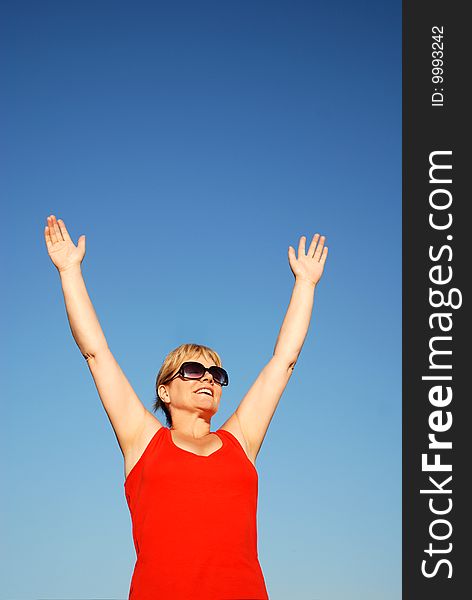 Happy woman cheering outside on a sunny day