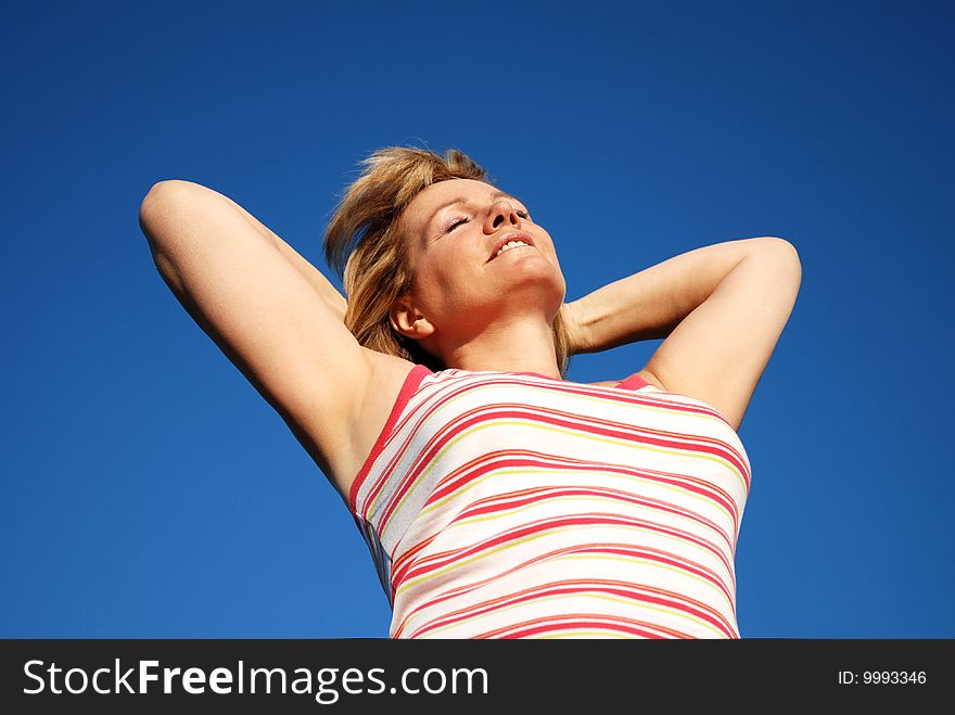 Woman relaxing ourdoors in the sun. Woman relaxing ourdoors in the sun