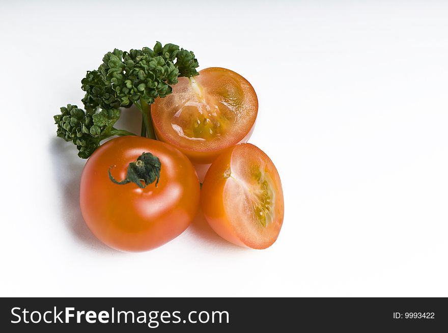 Cherry tomato and parsley on white background