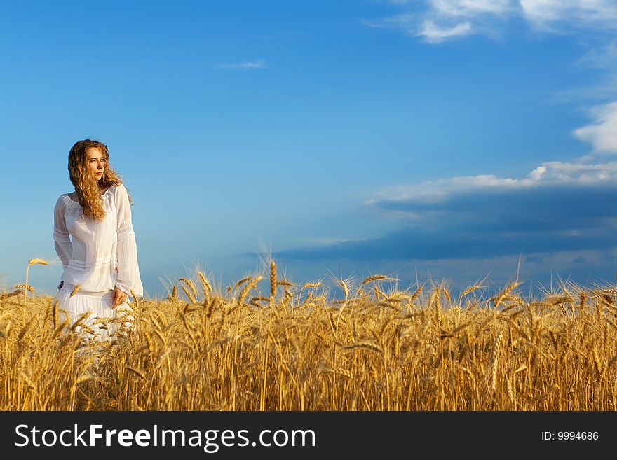 Woman in wheat field at sunset. Woman in wheat field at sunset
