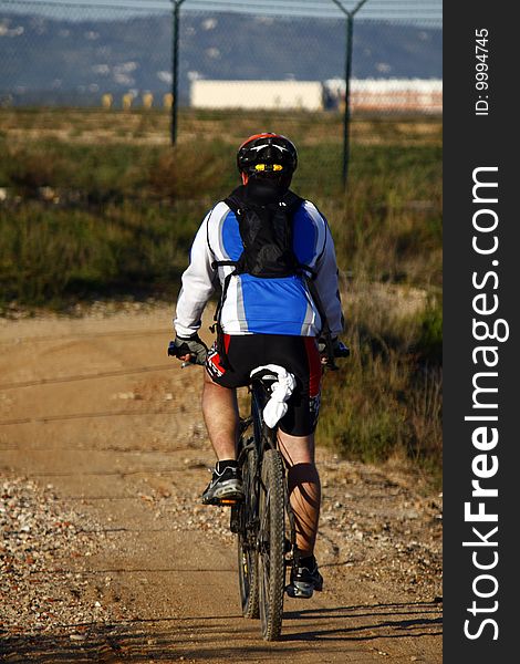 Man wearing sport cloths, riding a bike on the countryside. Man wearing sport cloths, riding a bike on the countryside.