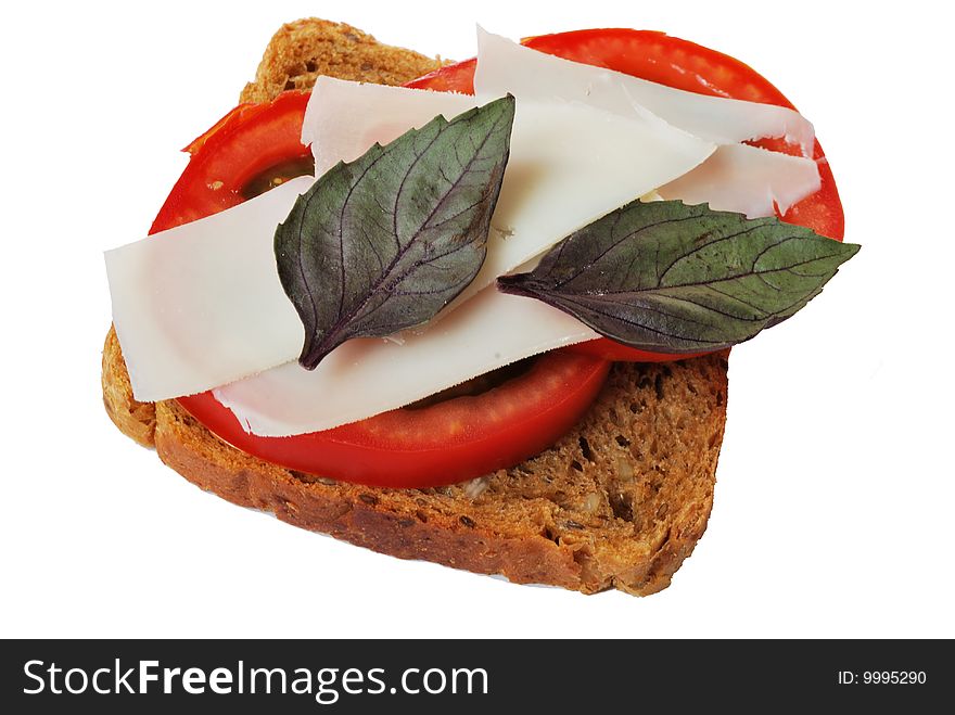 Sandwich with goat's cheese and tomatoes on white background