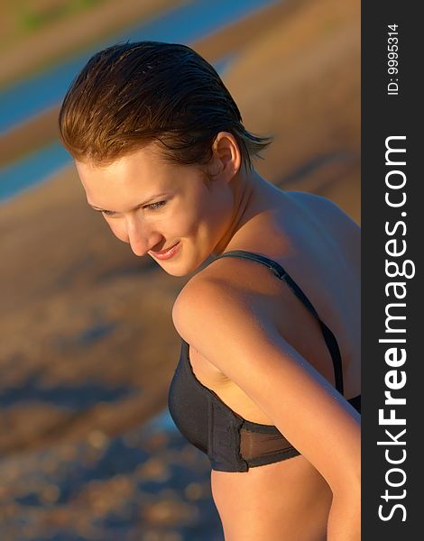 Girl on the beach, lit evening sun