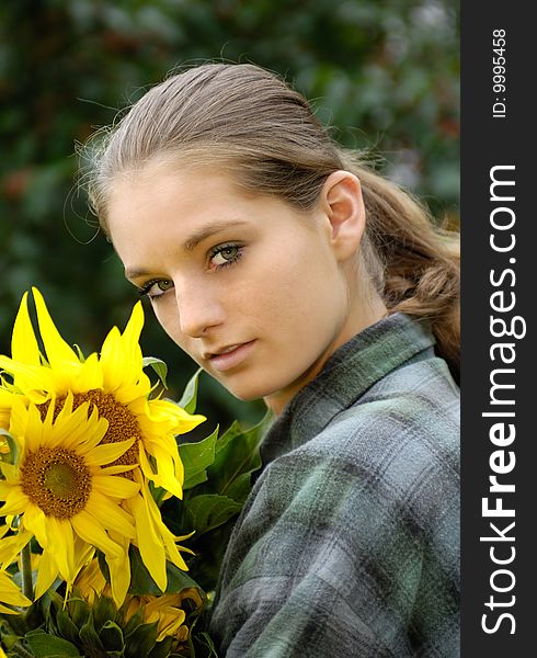 Young gardener woman with sunflower. Young gardener woman with sunflower