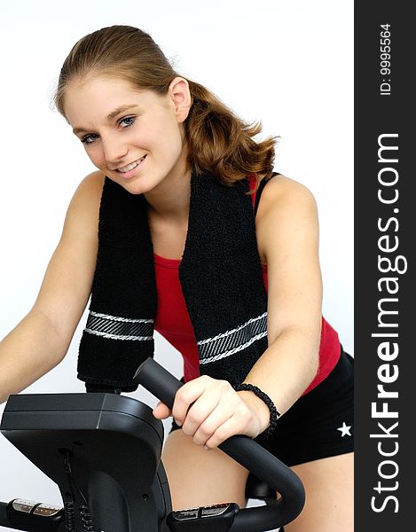 Young sporty woman on a ergometer