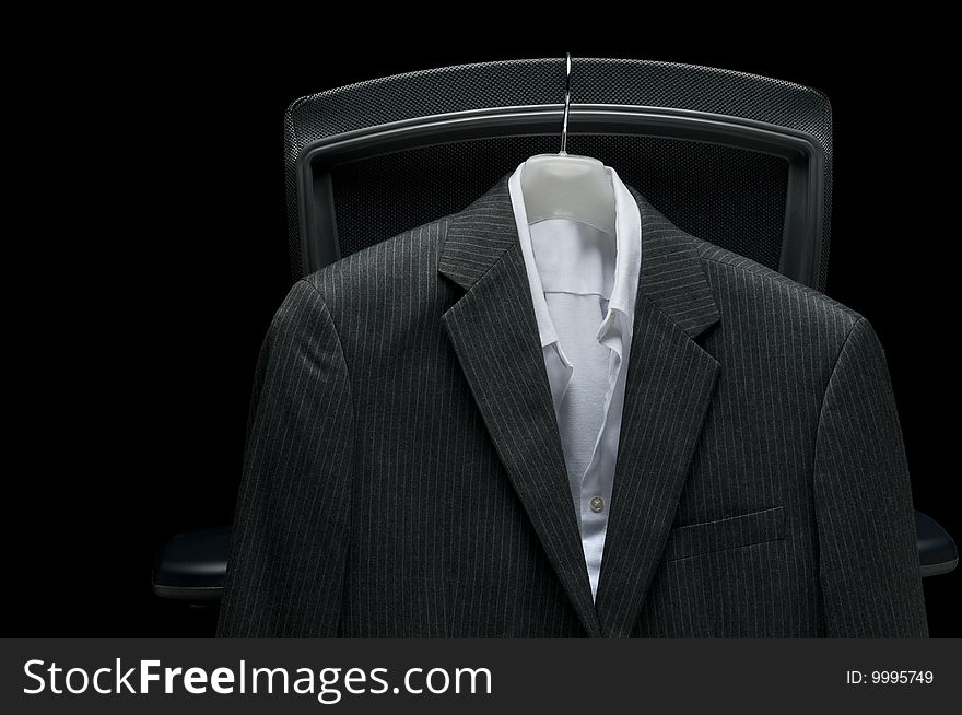 Business jacket and white shirt hanging on the back of an office chair. Business jacket and white shirt hanging on the back of an office chair