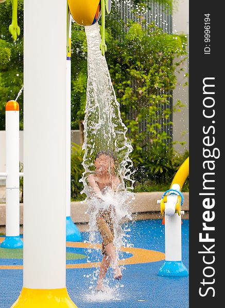 Boy trying to intercept the water pouring from a bucket at random intervals. Boy trying to intercept the water pouring from a bucket at random intervals