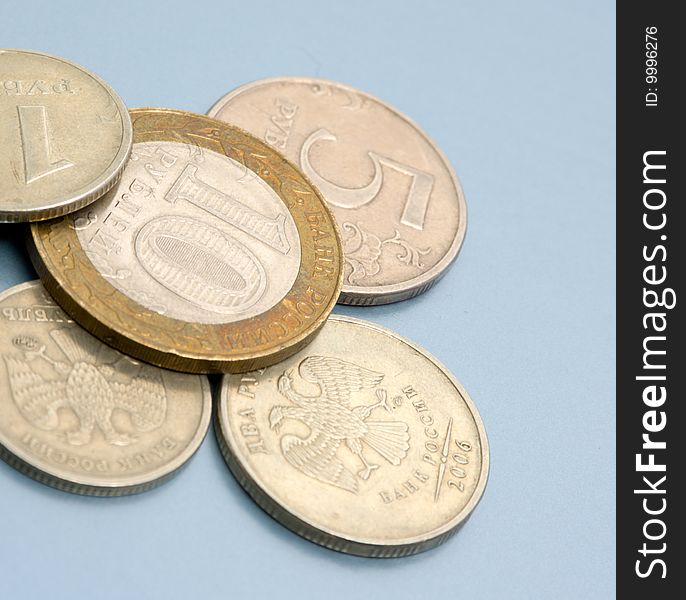 Coins on colored (blue) background. Close-up. Coins of Russian Federation bank. Coins on colored (blue) background. Close-up. Coins of Russian Federation bank