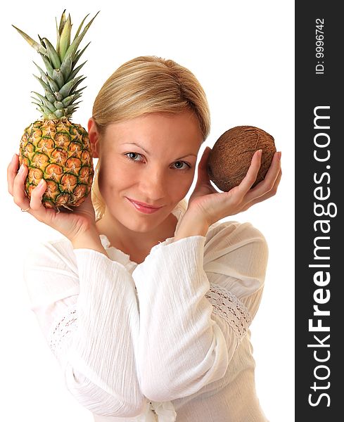 A beautiful girl holds a pineapple and coconut. A beautiful girl holds a pineapple and coconut.