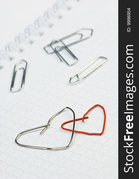Two paper-clips, formed to as a heart. Two paper-clips, formed to as a heart