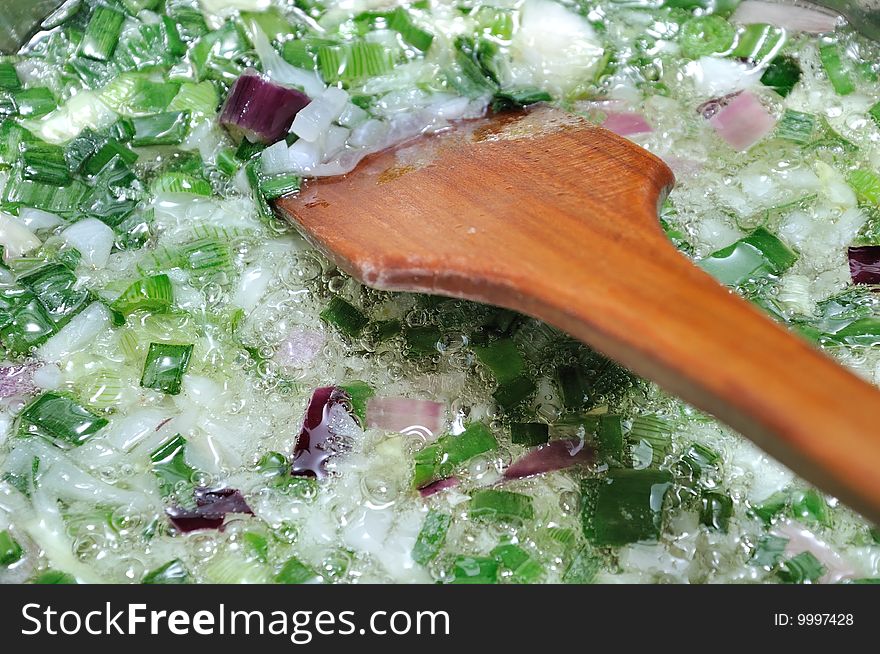 Cooking spring onion for a cabbage dish