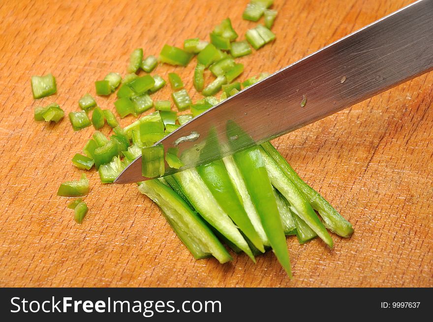 Chopping pepper with knife in small pieces. Chopping pepper with knife in small pieces.
