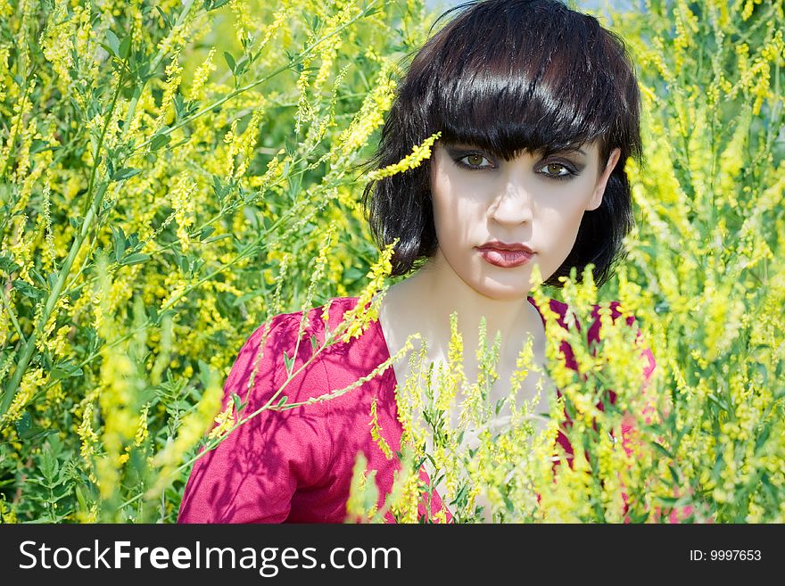 The portrait of girl in the environment of yellow flowers. The portrait of girl in the environment of yellow flowers.