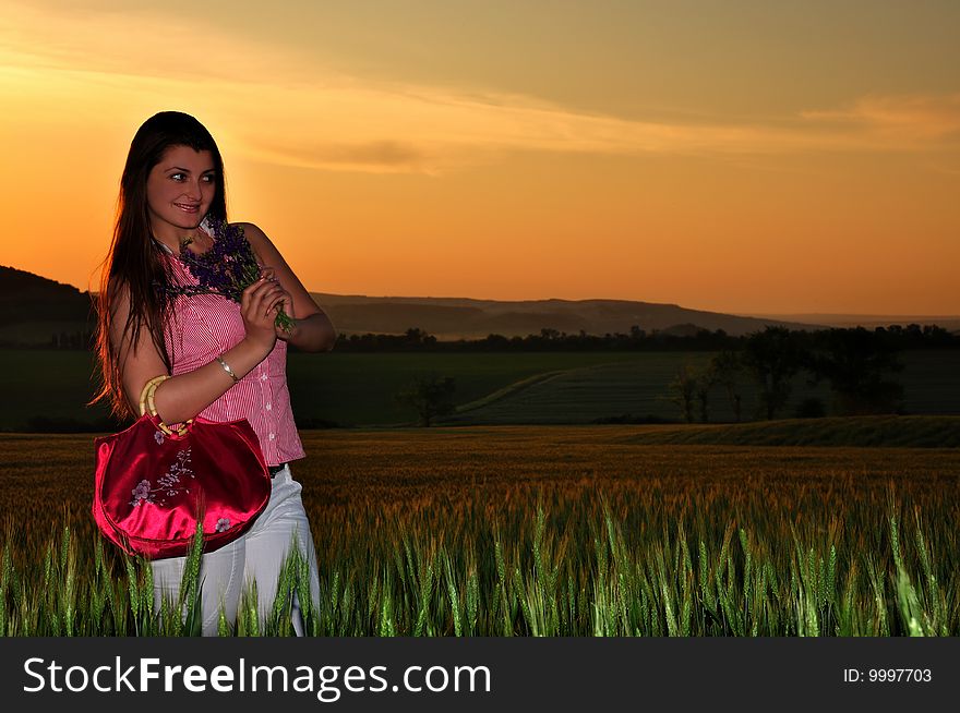 Girl in a field and orange sunset. Girl in a field and orange sunset