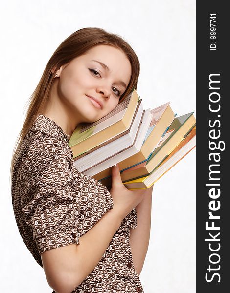 Image of a girl carrying a lot of books. Image of a girl carrying a lot of books