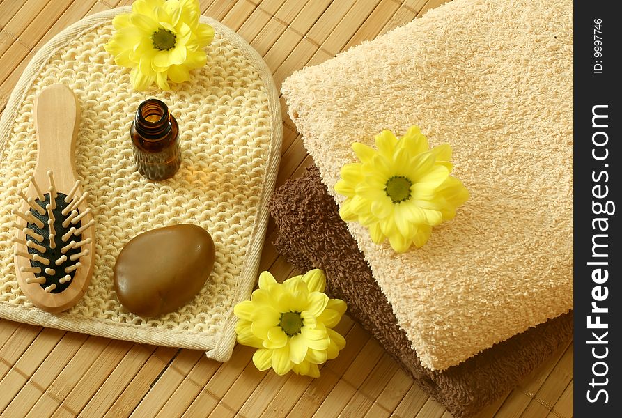 Spa background. towel, bottle, stone and flowers