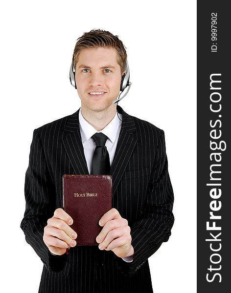 This is an image of man holding a bible and wearing a headset. This is an image of man holding a bible and wearing a headset.