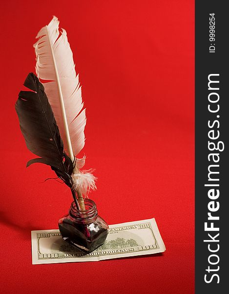 Feather quill, ink and money