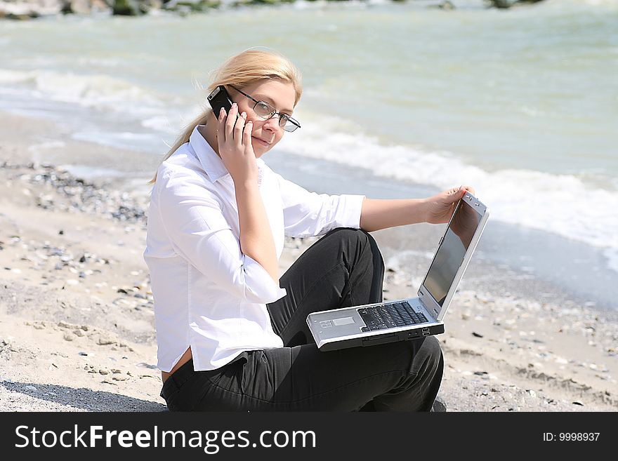 Businesswoman with business suit working on the beach. Businesswoman with business suit working on the beach