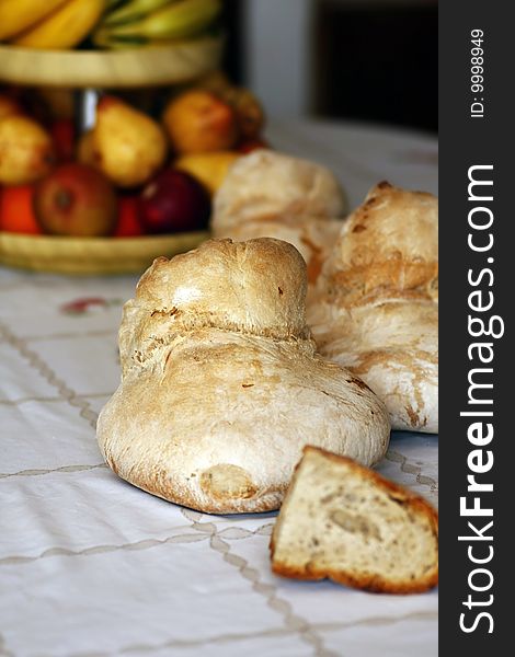 View of some traditional portuguese breads and a bowl of fruit. View of some traditional portuguese breads and a bowl of fruit.