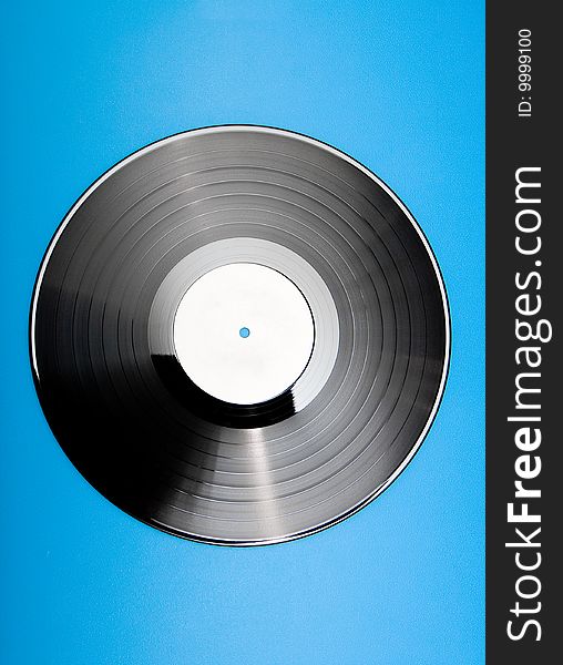 Vinyl disc with blank label on blue background. Vinyl disc with blank label on blue background