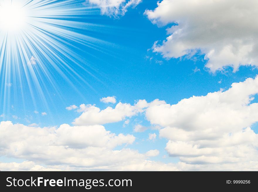 Blue sky is covered by white clouds and sun beams. Blue sky is covered by white clouds and sun beams.