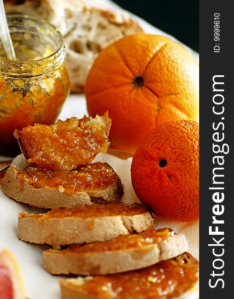 View of some slices of bread with orange jam on them.