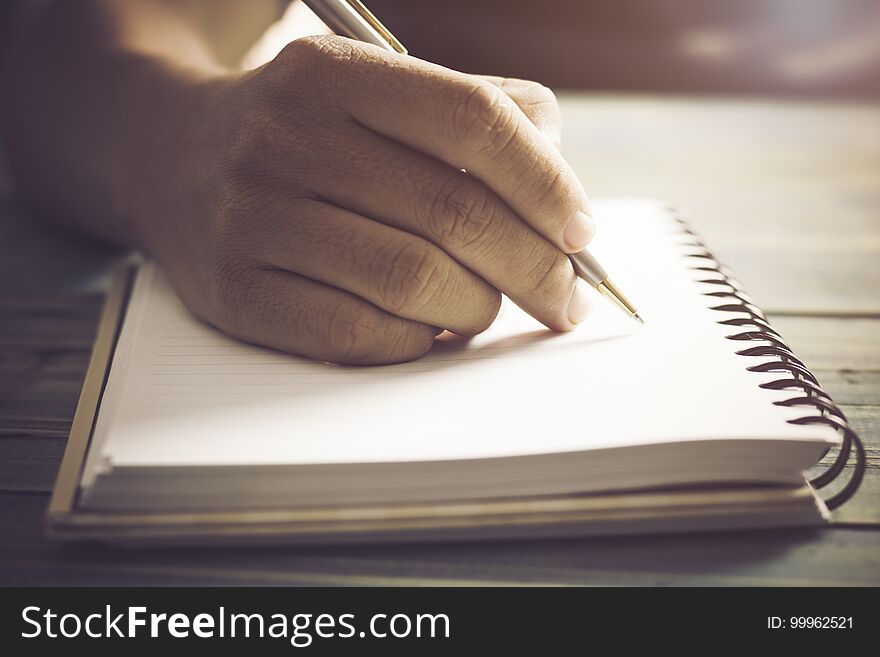 Writing dairy on notebook in coffee shop, concept as memory of life