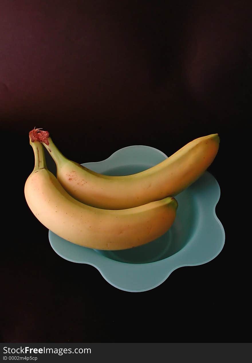 Two fresh bananas on a blue dish. Two fresh bananas on a blue dish