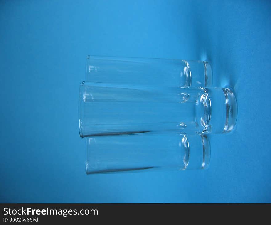 A closeup of three jiggers on blue background. A closeup of three jiggers on blue background.