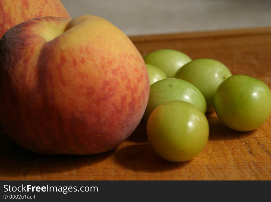 A subtle selection of garden peaches and greengages, ready for preparation. A subtle selection of garden peaches and greengages, ready for preparation.