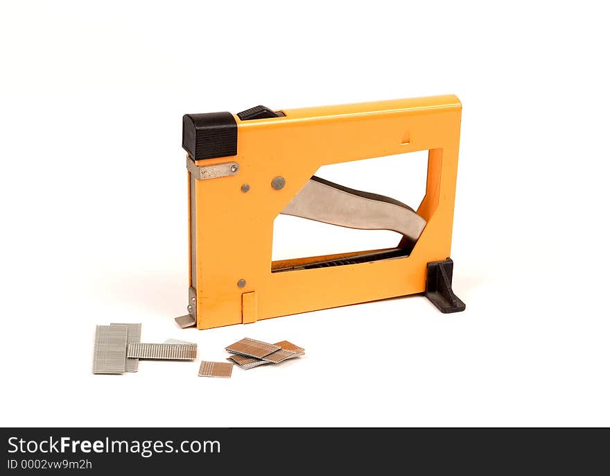 Framer's nail gun for mounting prints into a frame. Gun loads with nails laying in front of gun. Framer's nail gun for mounting prints into a frame. Gun loads with nails laying in front of gun.