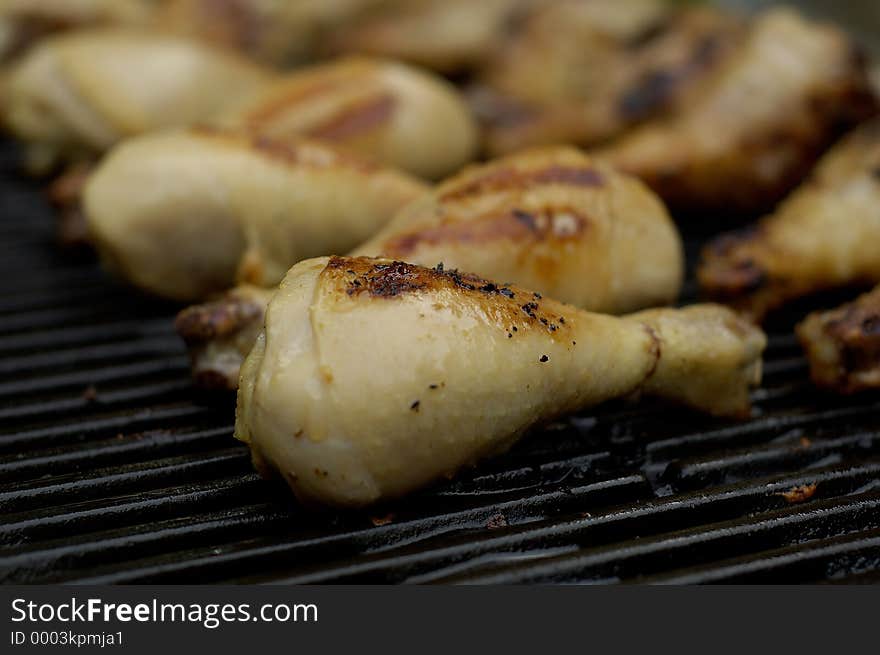 Chicken drumsticks on the barbeque, being grilled up. Chicken drumsticks on the barbeque, being grilled up