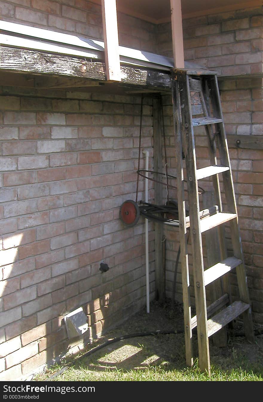 A ladder and some other stuff leaning up against the outside of my grandfather's house. A ladder and some other stuff leaning up against the outside of my grandfather's house.