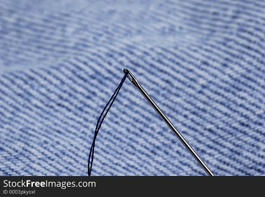 Photo of Sewing Needle and Denim Fabric