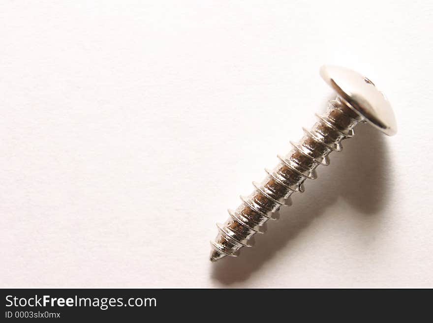 Close-up photo of a metal screw. Close-up photo of a metal screw.