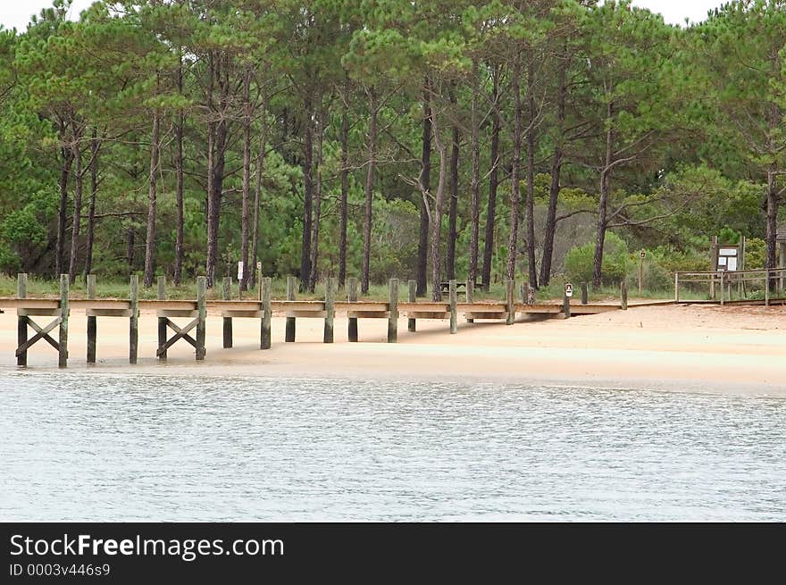 Walkway leading to dry land from the pier on Cape Lookout, North Carolina. Photo taken at low tide. Walkway leading to dry land from the pier on Cape Lookout, North Carolina. Photo taken at low tide