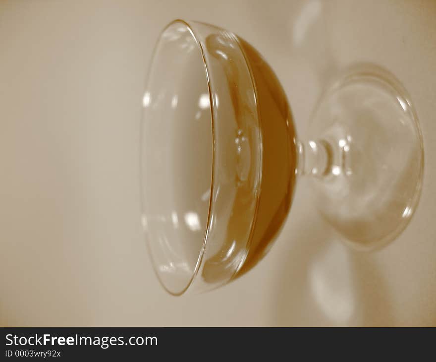 A glass with red liqueur in sepia. A glass with red liqueur in sepia.