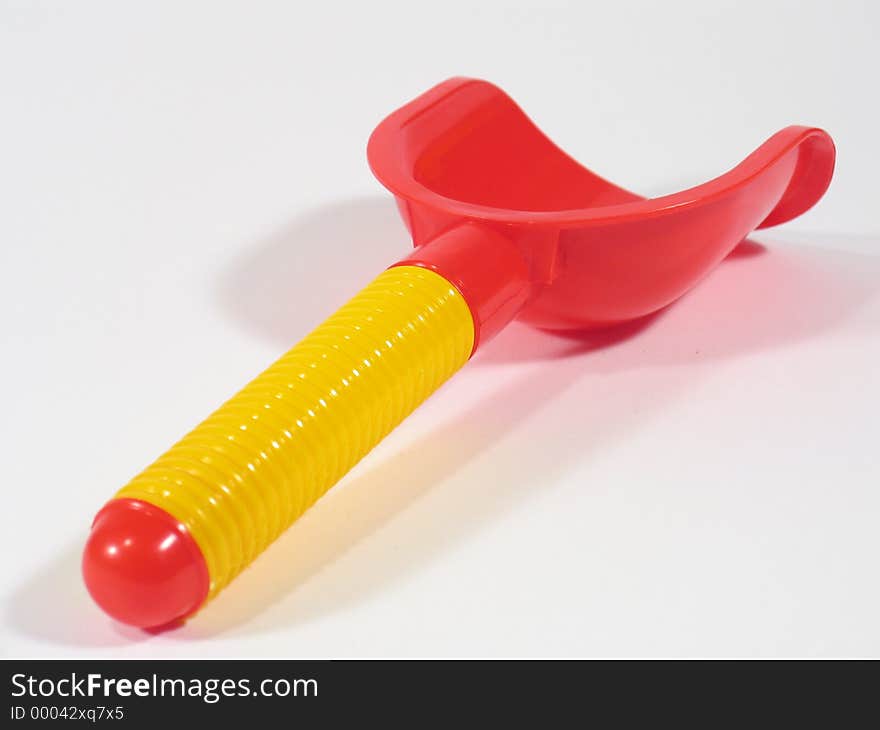 Haft of a yellow-colored and red-colored sandbox toy shovel. Haft of a yellow-colored and red-colored sandbox toy shovel.