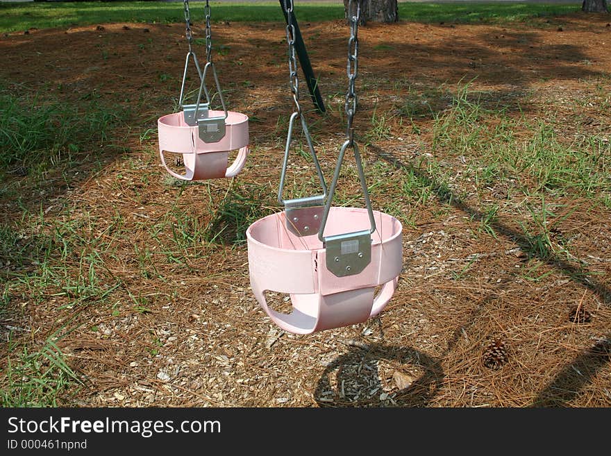 Pink baby swings in playground
