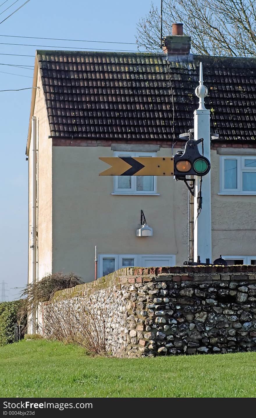 Restored old British railway yellow caution signal ( UK term: distant ) in the back garden of a house in Norfolk, England. Restored old British railway yellow caution signal ( UK term: distant ) in the back garden of a house in Norfolk, England.