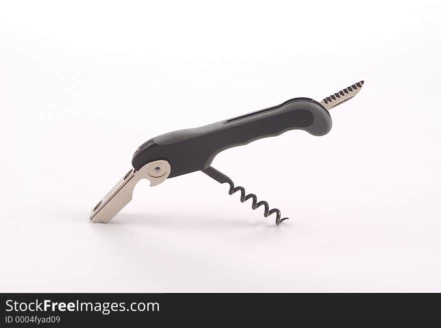 A wine tool featuring a cork screw, lever and knife photographed on a white background