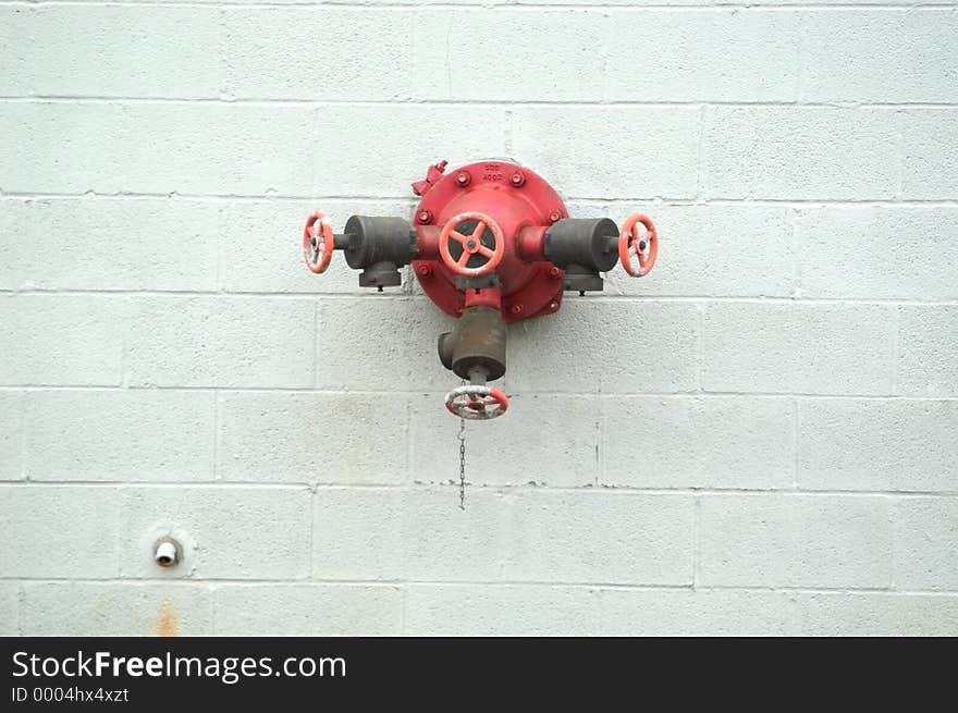 A connector on an industrial building for fire hoses. Supply of water in case of a fire. A connector on an industrial building for fire hoses. Supply of water in case of a fire