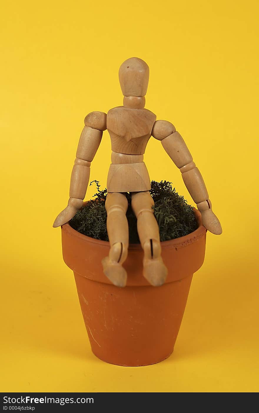 Photo of Mannequin Sitting on a Ceramic Pot. Photo of Mannequin Sitting on a Ceramic Pot.