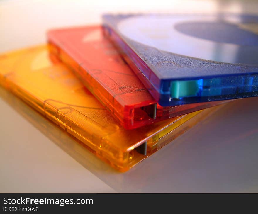 A macro / close-up of 3 coloufull Minidiscs (one Orange, one Red & one Blue). Superb macro shot.