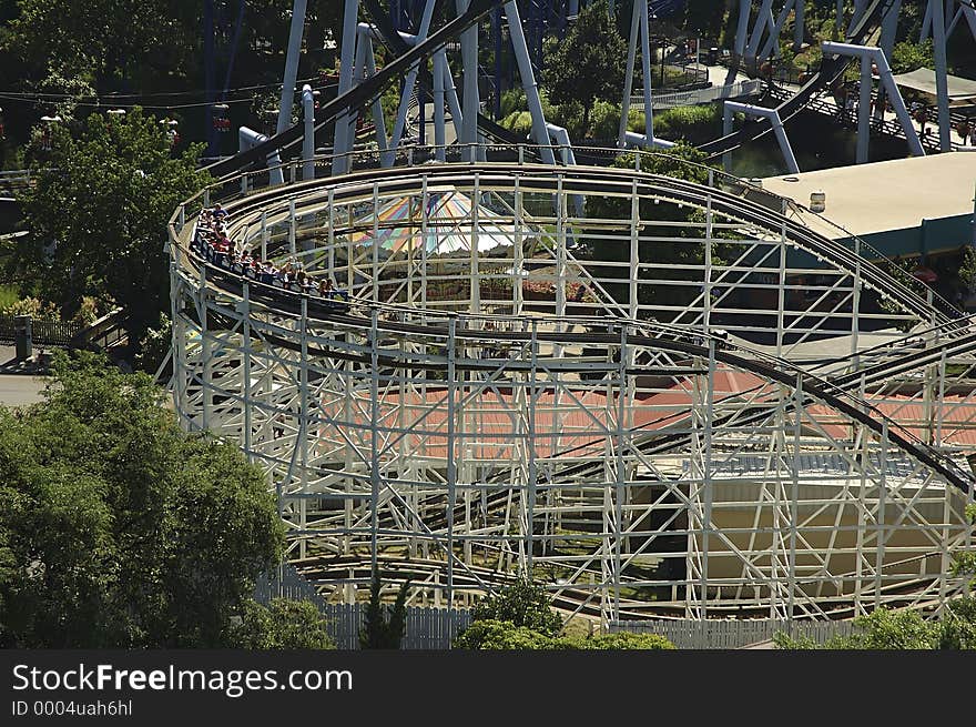 Photo of Rollercoaster With Cars Ready To Make The Drop. Photo of Rollercoaster With Cars Ready To Make The Drop.