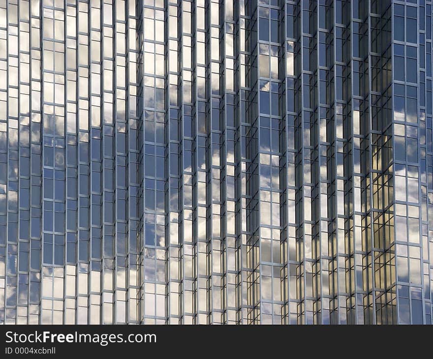 Blue sky and clouds reflected in the glass building in downtown Toronto. Blue sky and clouds reflected in the glass building in downtown Toronto