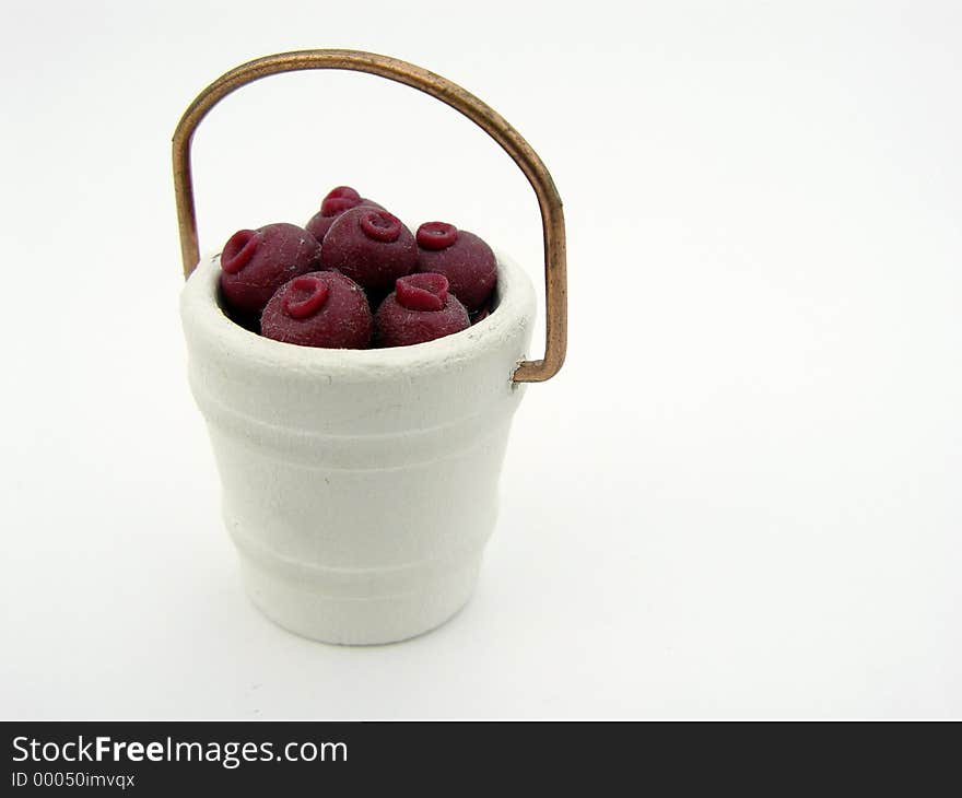 Fake Berries in a white bucket, isolated on white background. Fake Berries in a white bucket, isolated on white background