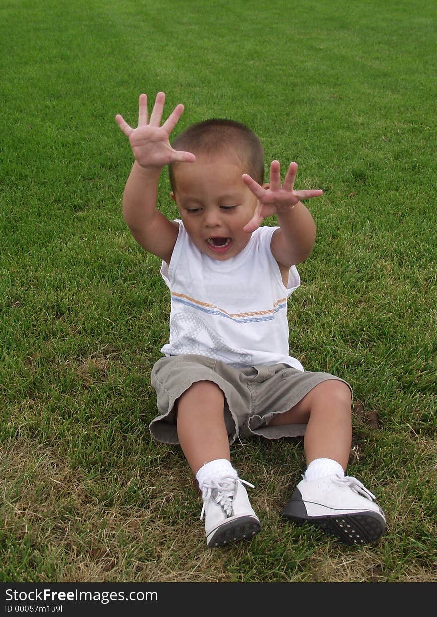 Toddler sitting on grass having fun. Toddler sitting on grass having fun