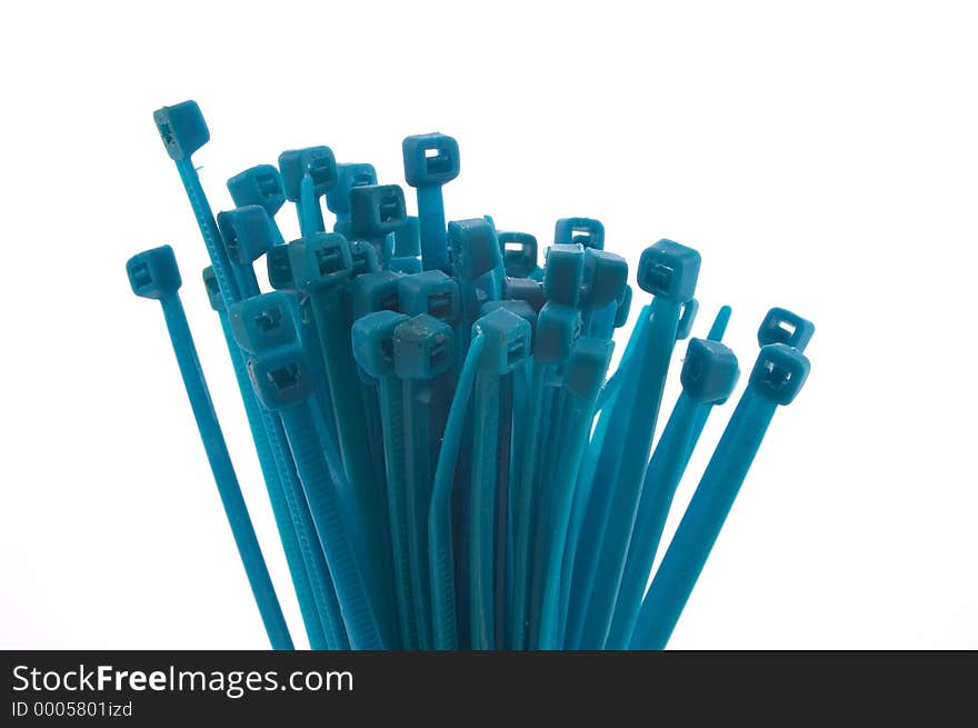 A grouping of aqua colored nylon ties bunched together and photographed on a white background